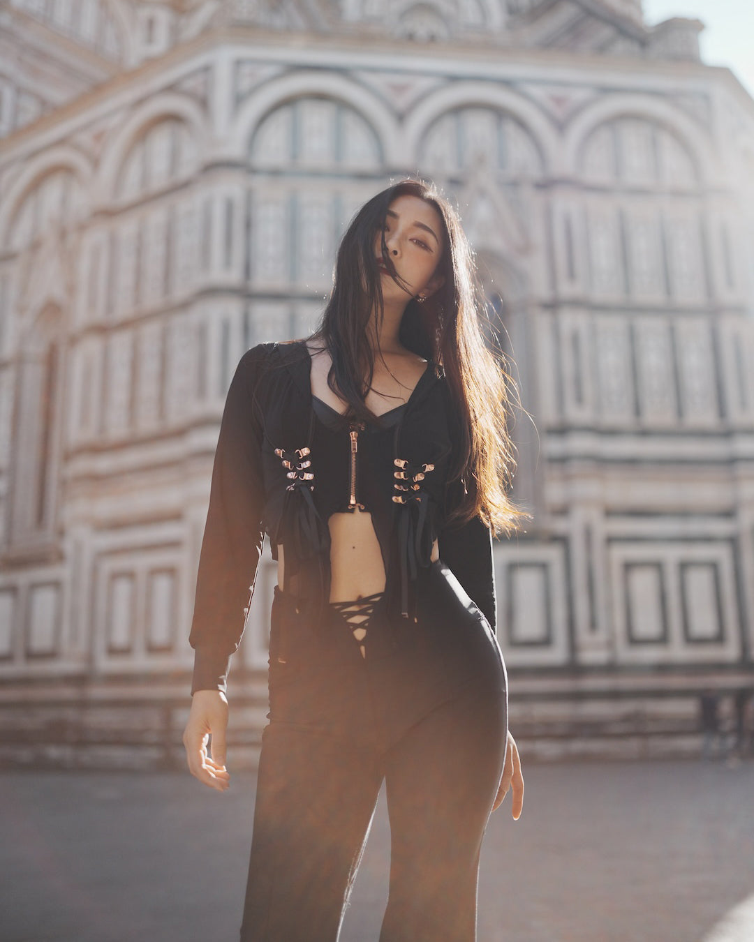 Black mesh hoodie styled over activewear set as street fashion